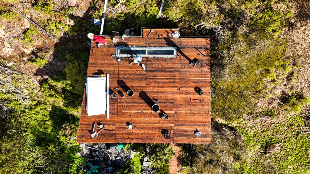 Aerial view of rooftop construction in lush greenery.