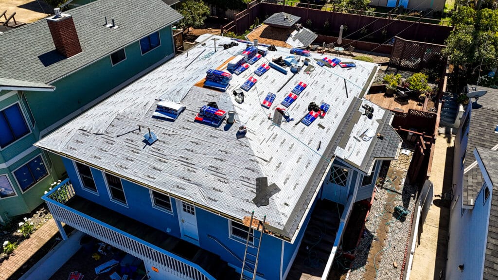 House roof under construction with materials ready.