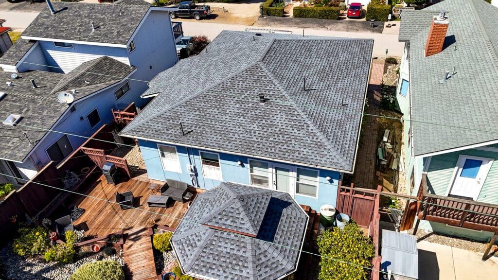 Aerial view of a residential house with backyard.