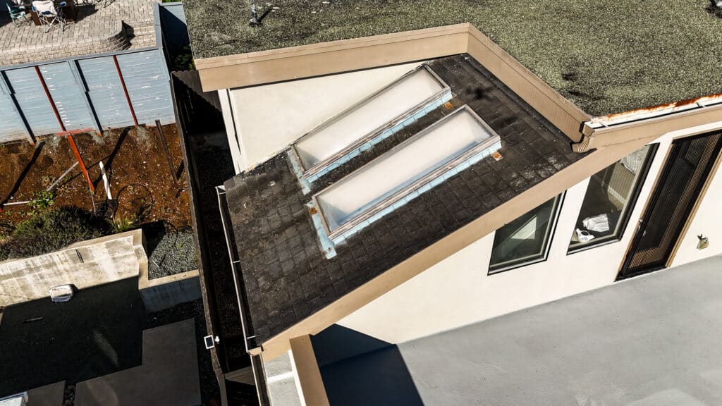 House rooftop with skylight windows view.