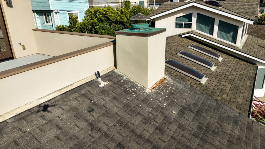 Modern rooftop with chimney and skylights