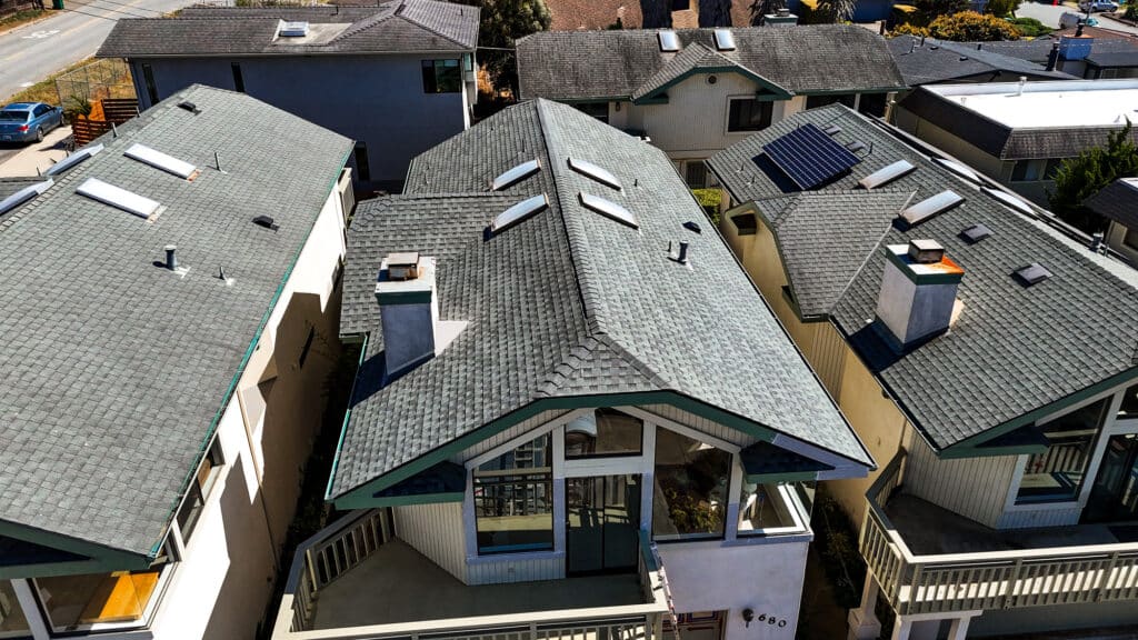 Aerial view of houses with shingle roofs.