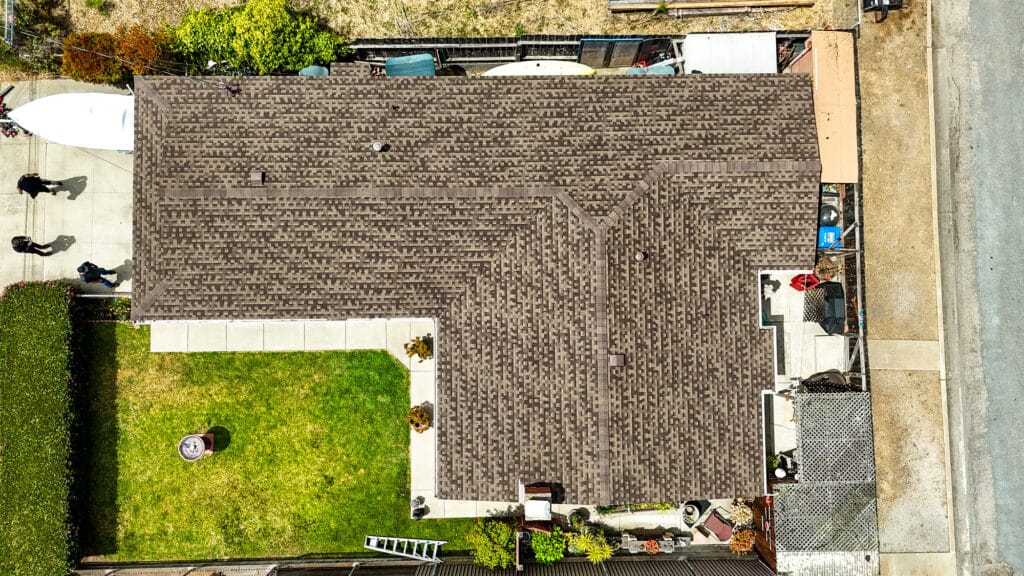 Aerial view of house and yard, sunny day.