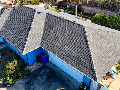 Aerial view of a house with gray shingle roof.