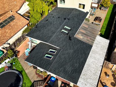default Aerial view of residential building roofs and yard.