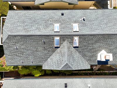 default Aerial view of house with gray roof and skylights.